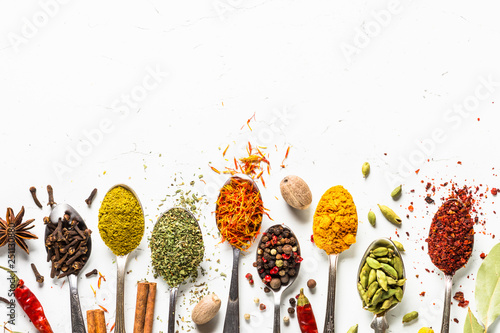 Set of various spices in spoons on white