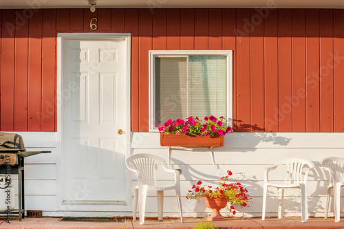 Typical small clean motel room with deck furniture, Canada