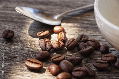 coffee beans in cup on wooden background