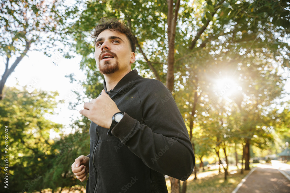 Young sports fitness man runner outdoors in park. Young sports fitness man runner outdoors in park.