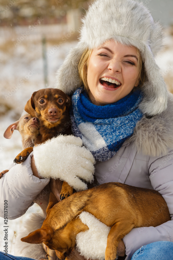 Woman playing with dogs during winter Woman playing with dogs during winter