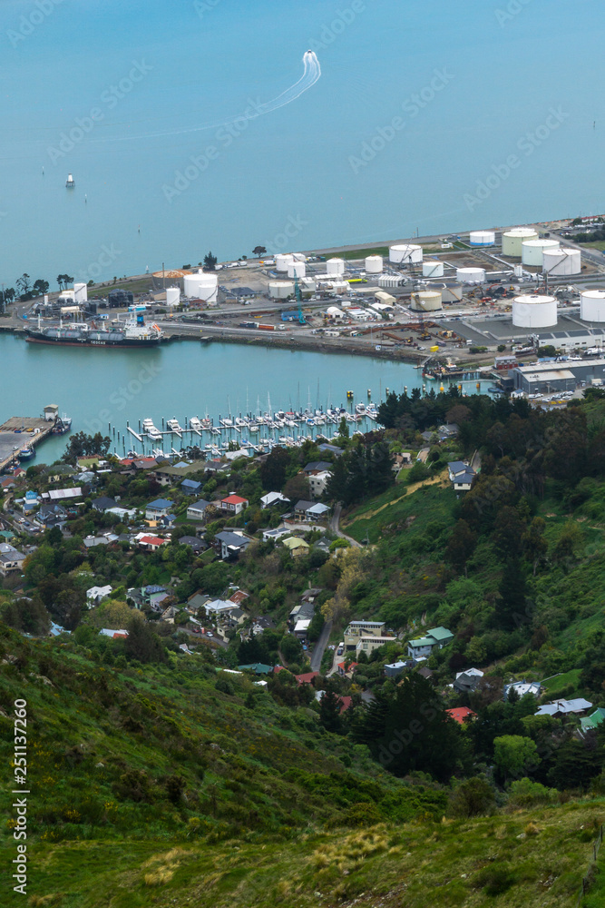 Small town, marina and port in distance surrounded by blue water