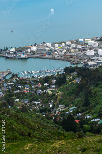 Small town, marina and port in distance surrounded by blue water
