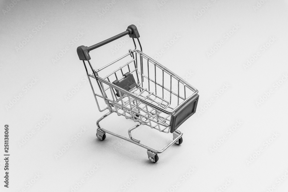 Shopping cart on black and white background, business and shopping concept. Selective focus Shopping cart on black and white background, business and shopping concept. Selective focus