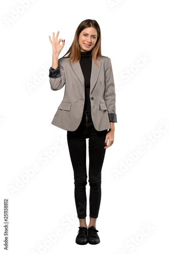 A full-length shot of a Business woman showing ok sign with fingers over isolated white background