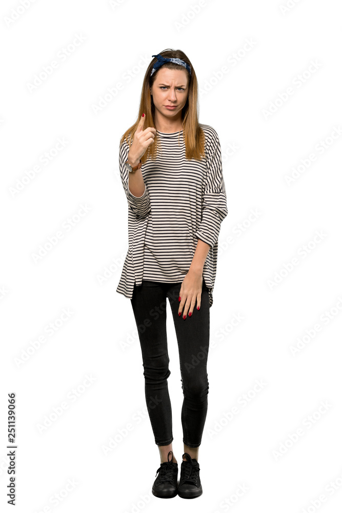 A full-length shot of a Young woman with headscarf frustrated and pointing to the front over isolated white background A full-length shot of a Young woman with headscarf frustrated and pointing to the front over isolated white background