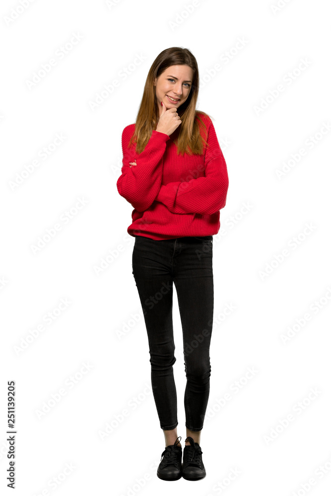 A full-length shot of a Young woman with red sweater looking to the side over isolated white background A full-length shot of a Young woman with red sweater looking to the side over isolated white background