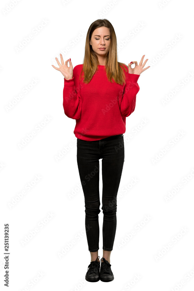 A full-length shot of a Young woman with red sweater in zen pose over isolated white background A full-length shot of a Young woman with red sweater in zen pose over isolated white background