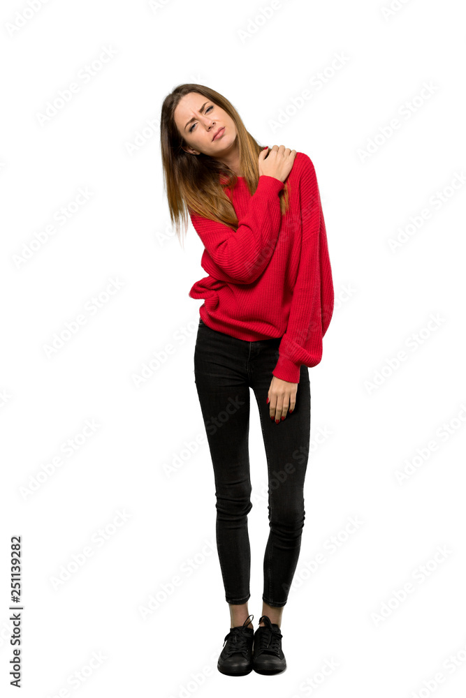 A full-length shot of a Young woman with red sweater suffering from pain in shoulder for having made an effort over isolated white background A full-length shot of a Young woman with red sweater suffering from pain in shoulder for having made an effort over isolated white background