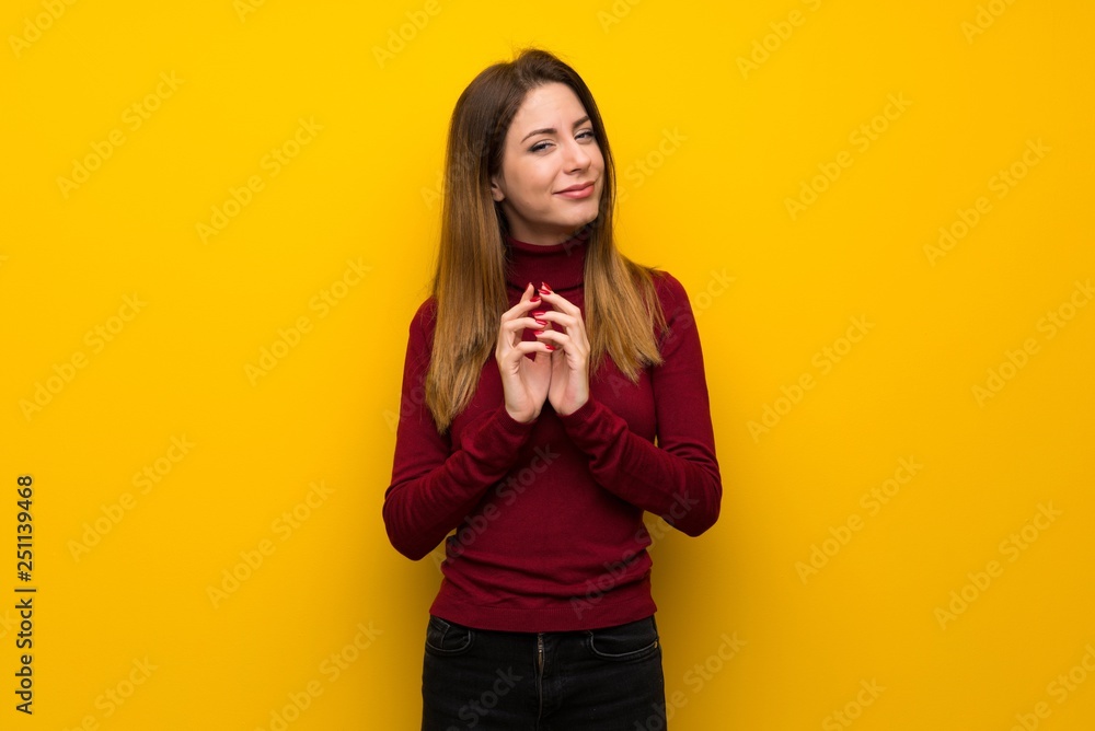 Woman with turtleneck over yellow wall scheming something Woman with turtleneck over yellow wall scheming something
