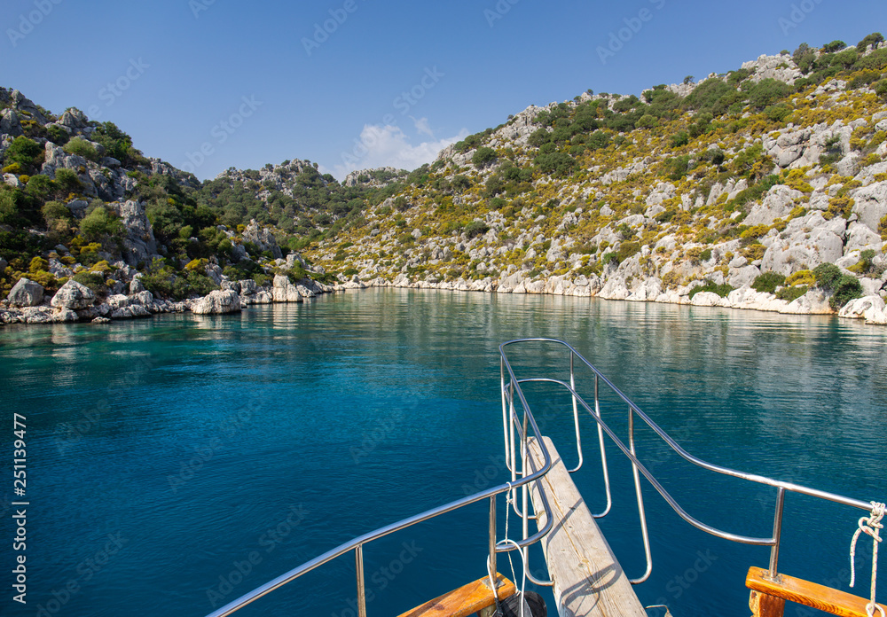 Naklejka premium Powerboat. View from the boat. Mediterranean sea overlooking the mountains. Aerial top view of sea waves hitting rocks on the beach with turquoise sea water.
