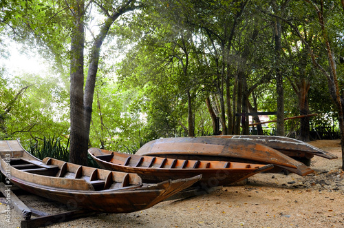Thai boats on the river bank in the background of trees