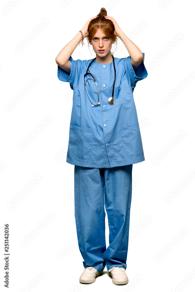 A full-length shot of a Young redhead nurse takes hands on head because has migraine over isolated white background A full-length shot of a Young redhead nurse takes hands on head because has migraine over isolated white background