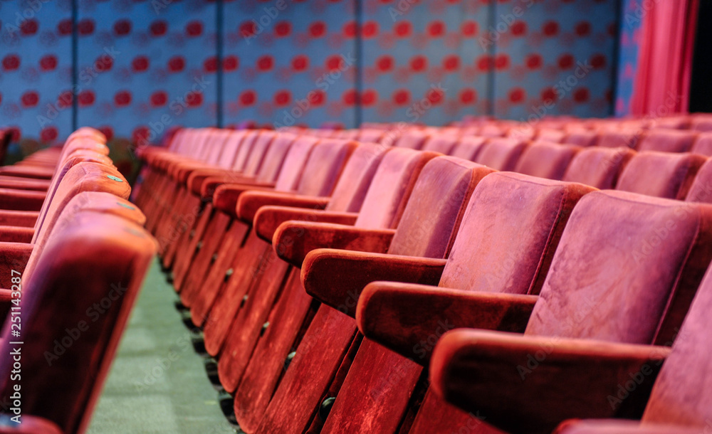 Fototapeta premium Cinema and music hall with comfortable red seats for audience