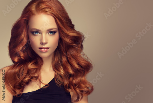 Fotografiet Beautiful model  girl with long curly red hair