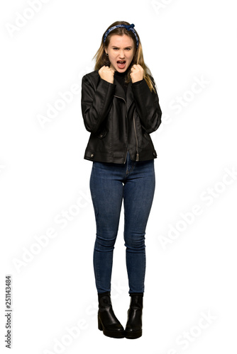 A full-length shot of a Teenager girl with leather jacket frustrated by a bad situation on isolated white background