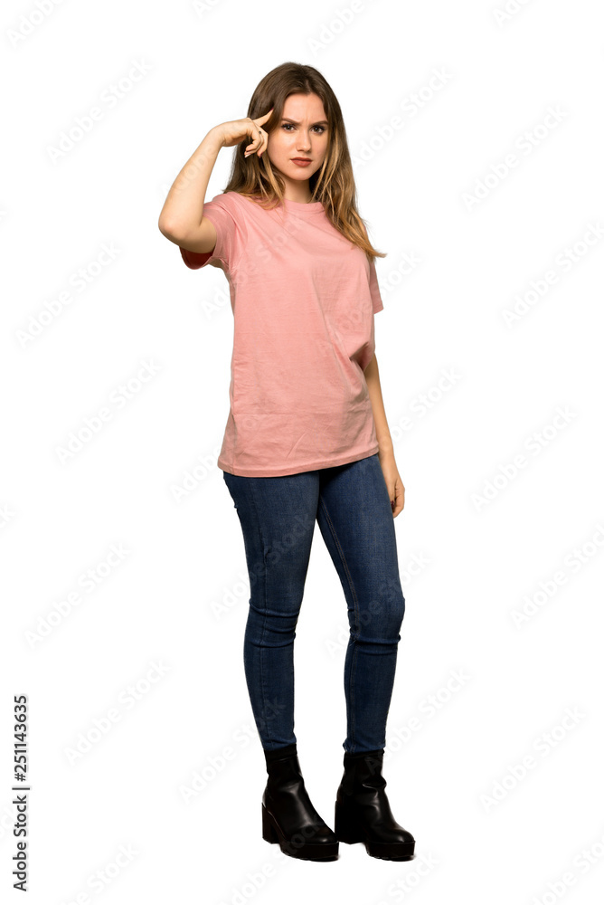 A full-length shot of a Teenager girl with pink sweater making the gesture of madness putting finger on the head on isolated white background A full-length shot of a Teenager girl with pink sweater making the gesture of madness putting finger on the head on isolated white background