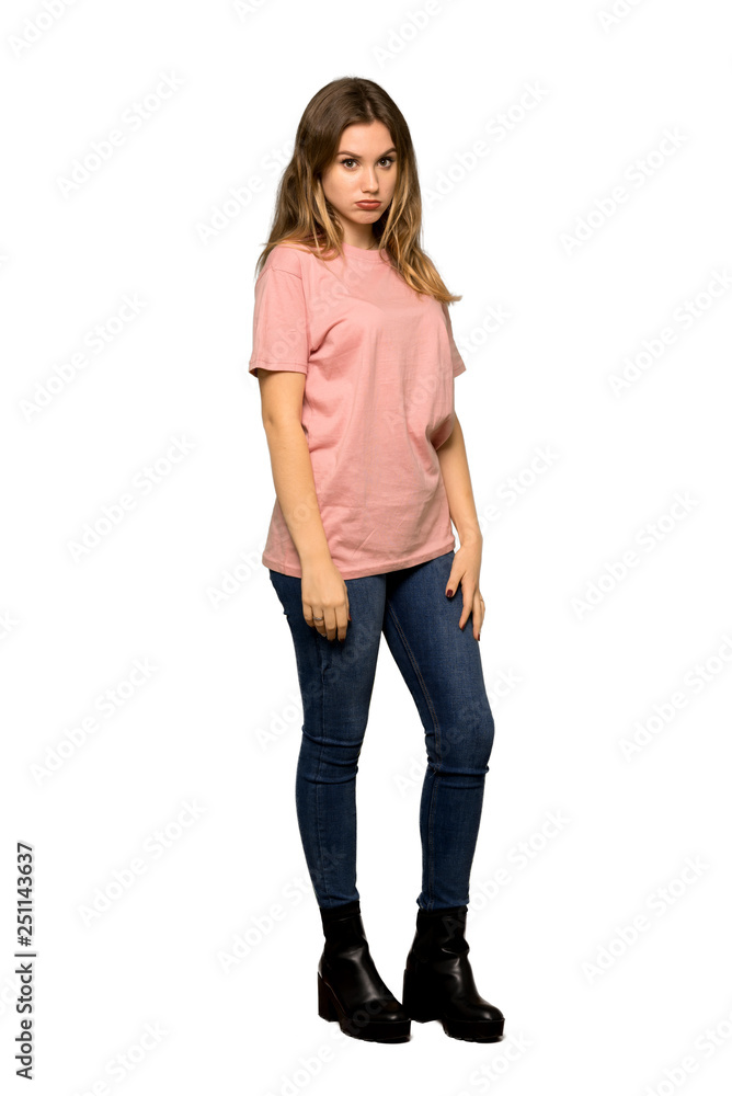 A full-length shot of a Teenager girl with pink sweater with sad and depressed expression on isolated white background A full-length shot of a Teenager girl with pink sweater with sad and depressed expression on isolated white background