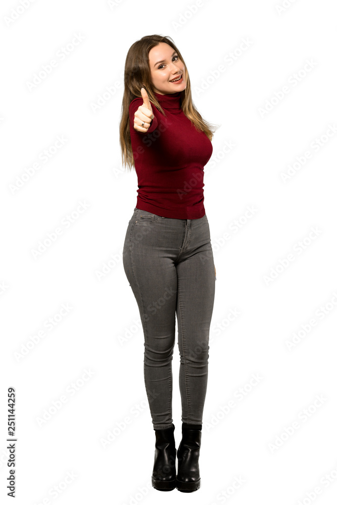 A full-length shot of a Teenager girl with turtleneck with thumbs up because something good has happened over isolated white background A full-length shot of a Teenager girl with turtleneck with thumbs up because something good has happened over isolated white background