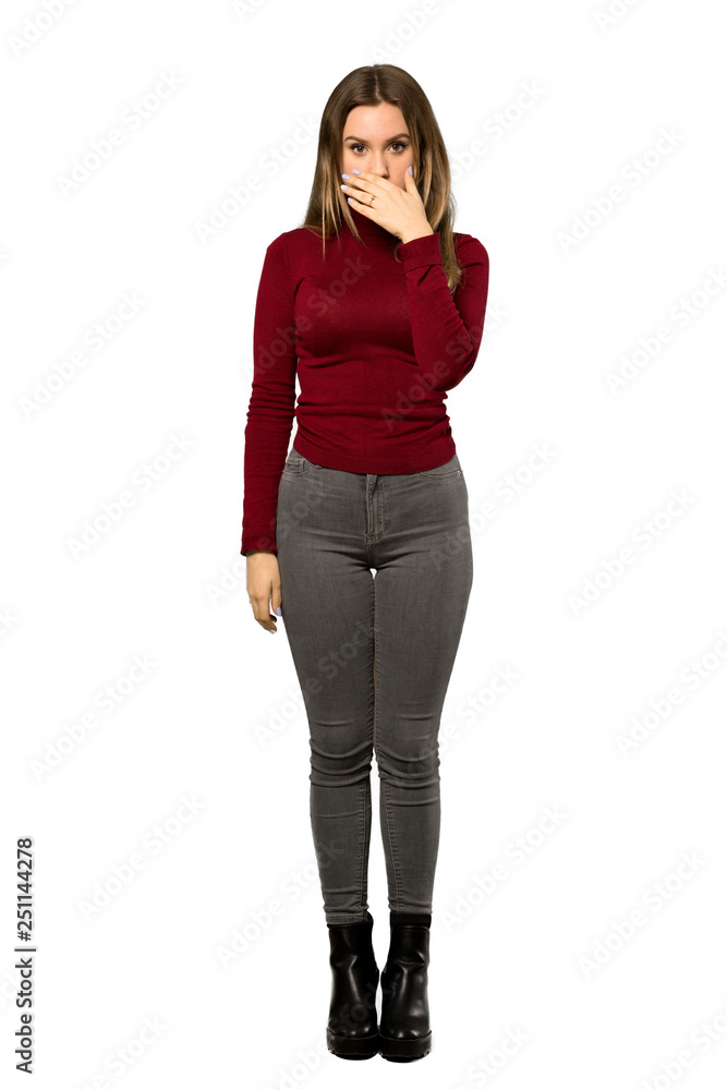 A full-length shot of a Teenager girl with turtleneck covering mouth with hands for saying something inappropriate over isolated white background A full-length shot of a Teenager girl with turtleneck covering mouth with hands for saying something inappropriate over isolated white background