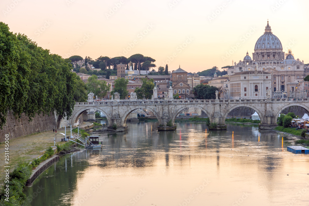 Sunset Panorama of Tiber River, St. Angelo Bridge and St. Peter's Basilica in Rome, Italy