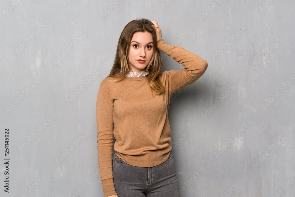 Teenager girl over textured wall with an expression of frustration and not understanding Teenager girl over textured wall with an expression of frustration and not understanding