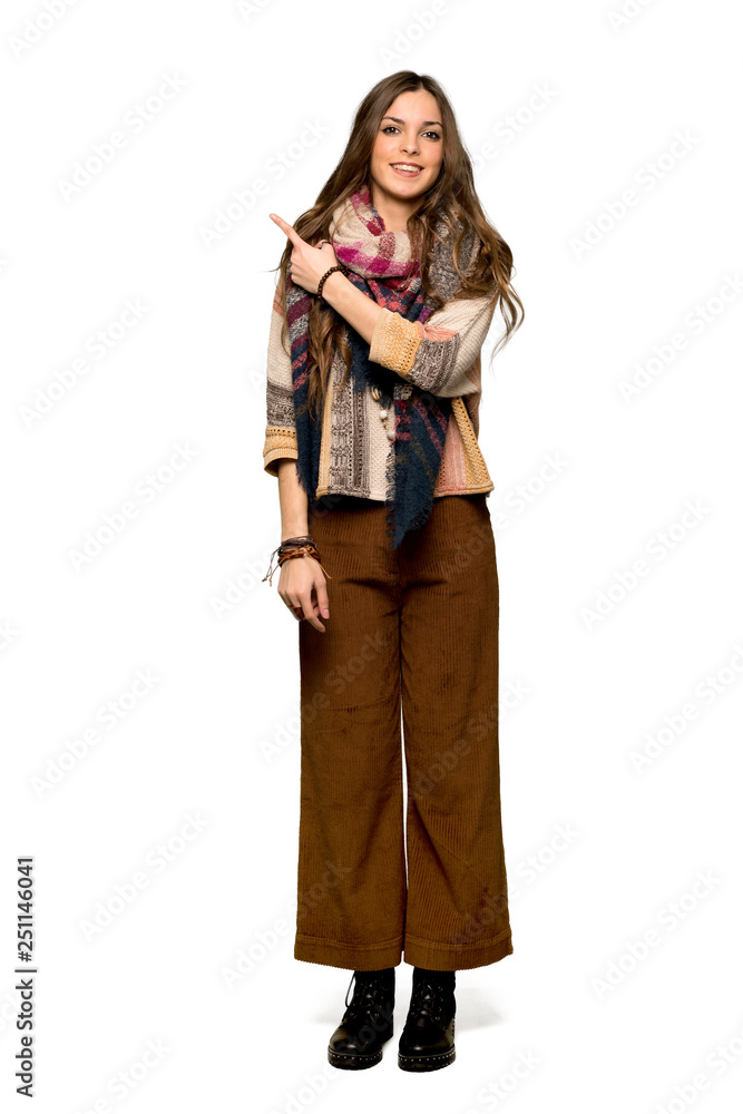 Full-length shot of Young hippie woman pointing to the side to present a product on isolated white background Full-length shot of Young hippie woman pointing to the side to present a product on isolated white background