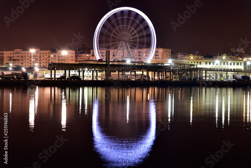 View of Malaga city and giant wheel from harbour, Malaga, Spain © akturer