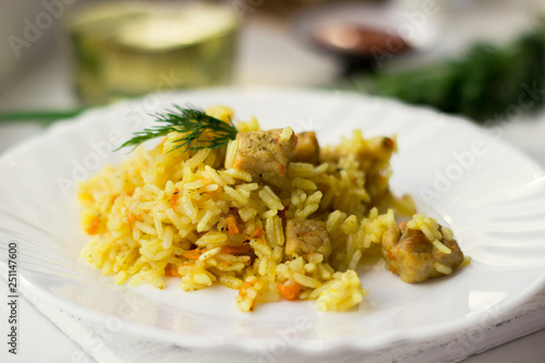 Traditional pilaf, rice with meat, carrots and onions on a white background.