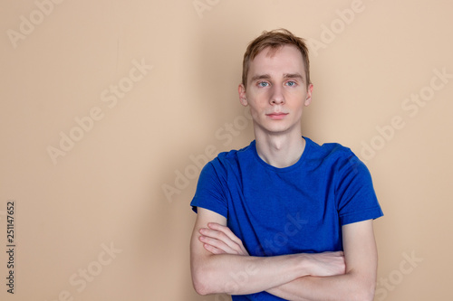 Young serious man posing and looking at camera