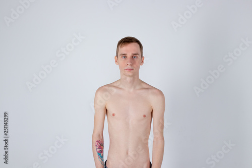 Young serious man posing and looking at camera