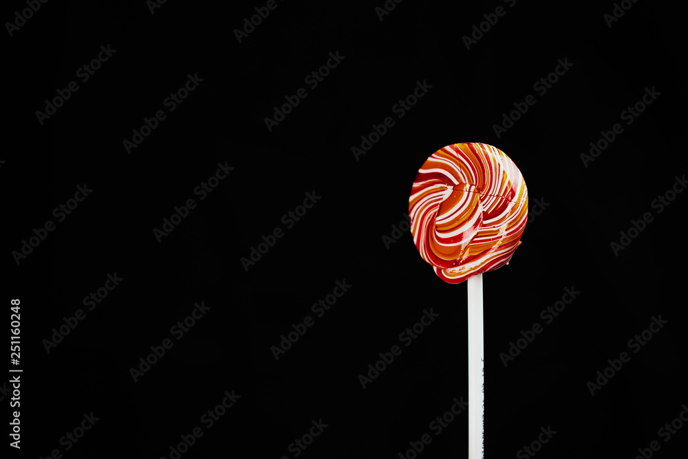 red, round colored Lollipop on black background red, round colored Lollipop on black background