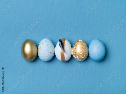 Row of golden and blue Easter eggs.