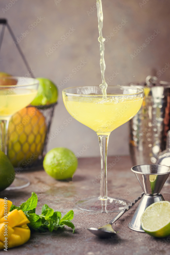 Margarita Mango alcoholic cocktail in a glass on stone background. Margarita Mango alcoholic cocktail in a glass on stone background.
