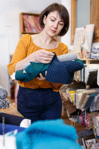 Woman looking for cloth in shop