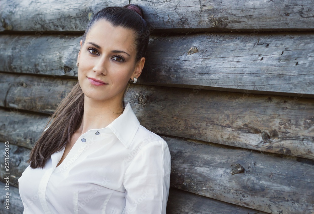 Outdoor portrait of a young, confident, sexy, beautiful brunette girl in white shirt Outdoor portrait of a young, confident, sexy, beautiful brunette girl in white shirt