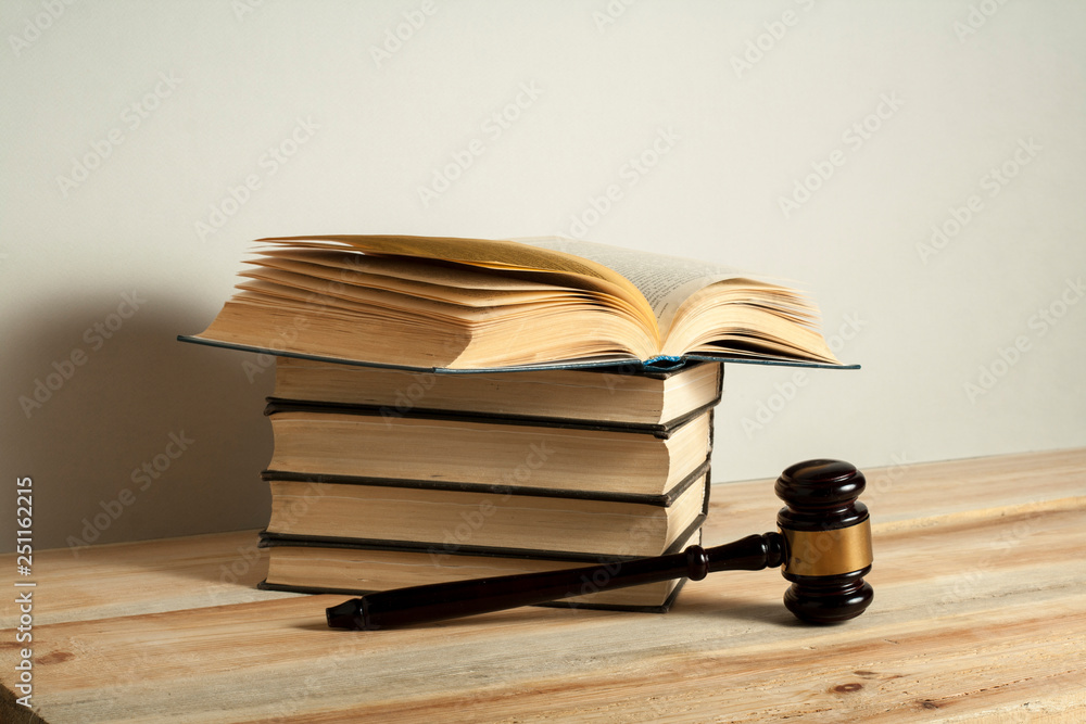 Law concept. Wooden judge gavel with law books on the table in a courtroom or enforcement office. Law concept. Wooden judge gavel with law books on the table in a courtroom or enforcement office.