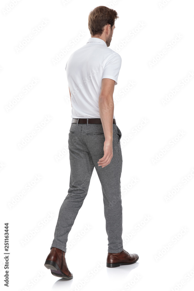 side rear view of a smart casual man walking away side rear view of a smart casual man walking away