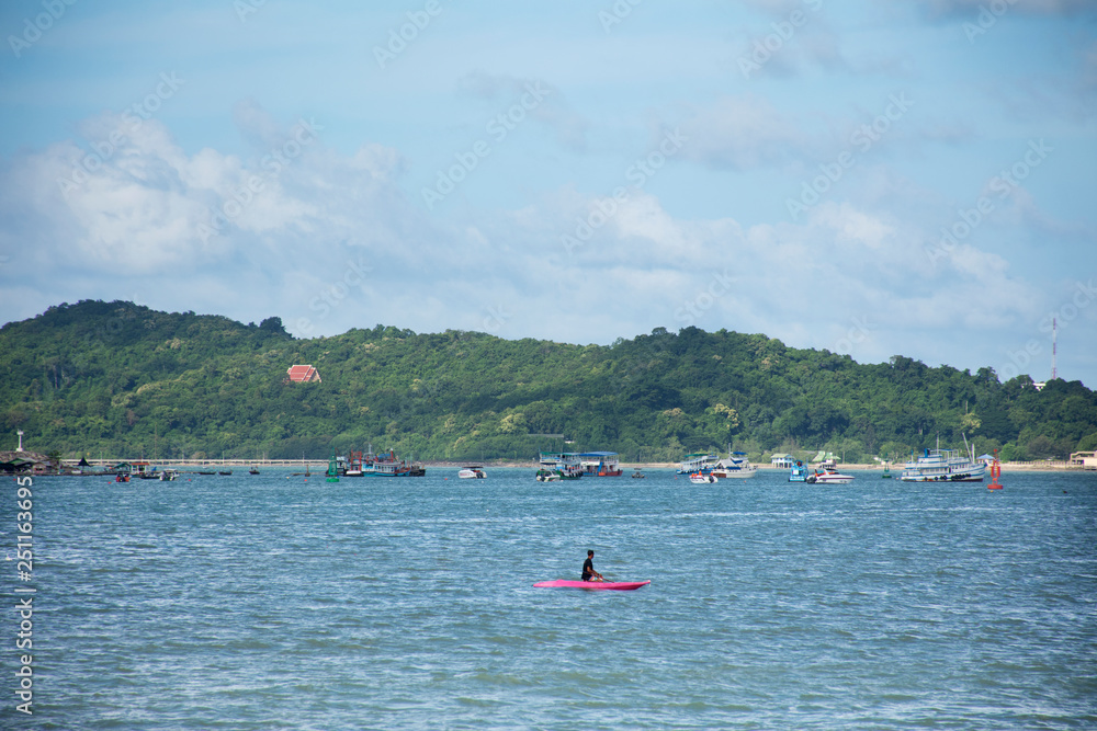 Traveler thai people playing and paddle boat canoe in the sea ocean at Ban Pae beach in Rayong, Thailand