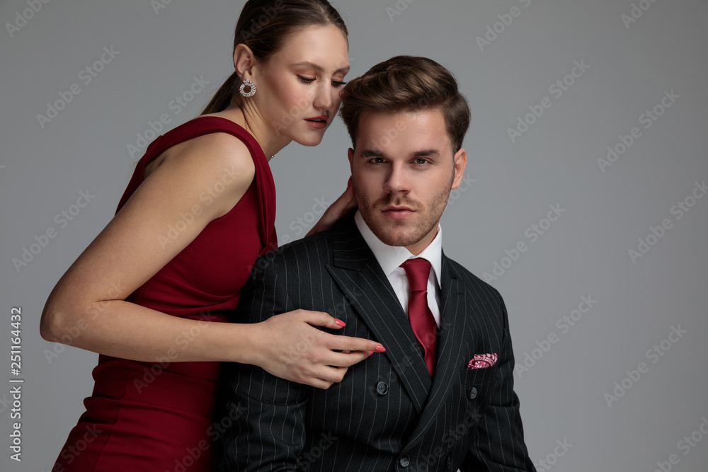 seated elegant man with his woman behind him seated elegant man with his woman behind him