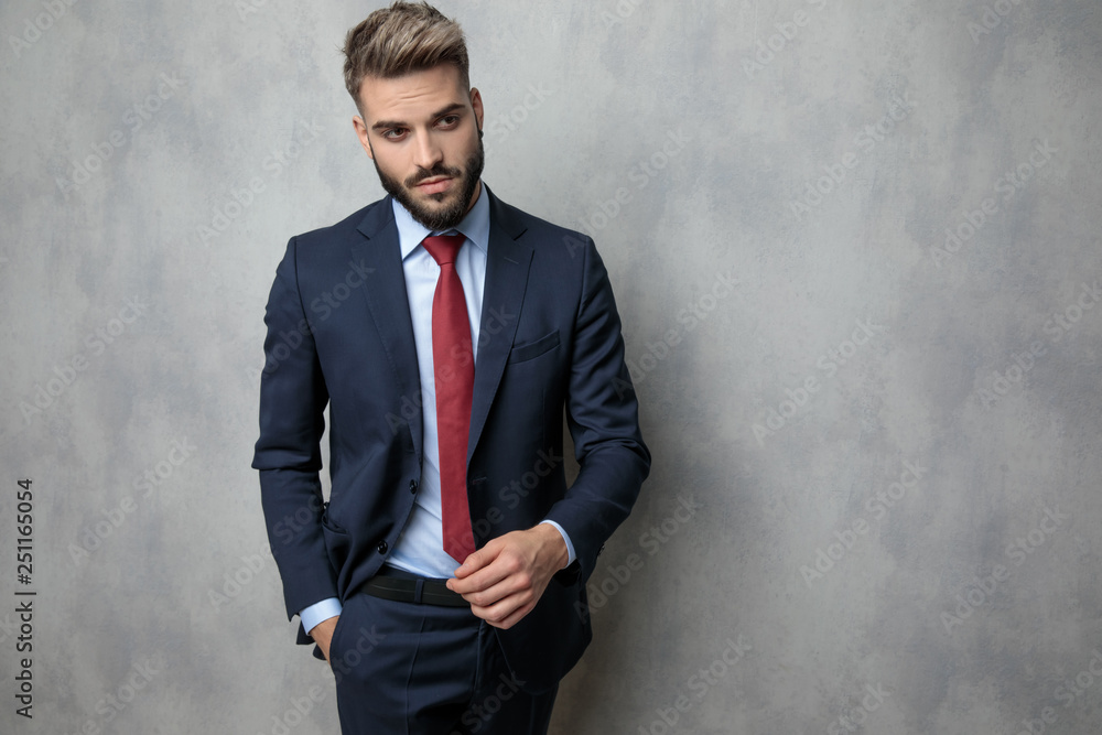 cool young businessman is walking with hand in pocket cool young businessman is walking with hand in pocket