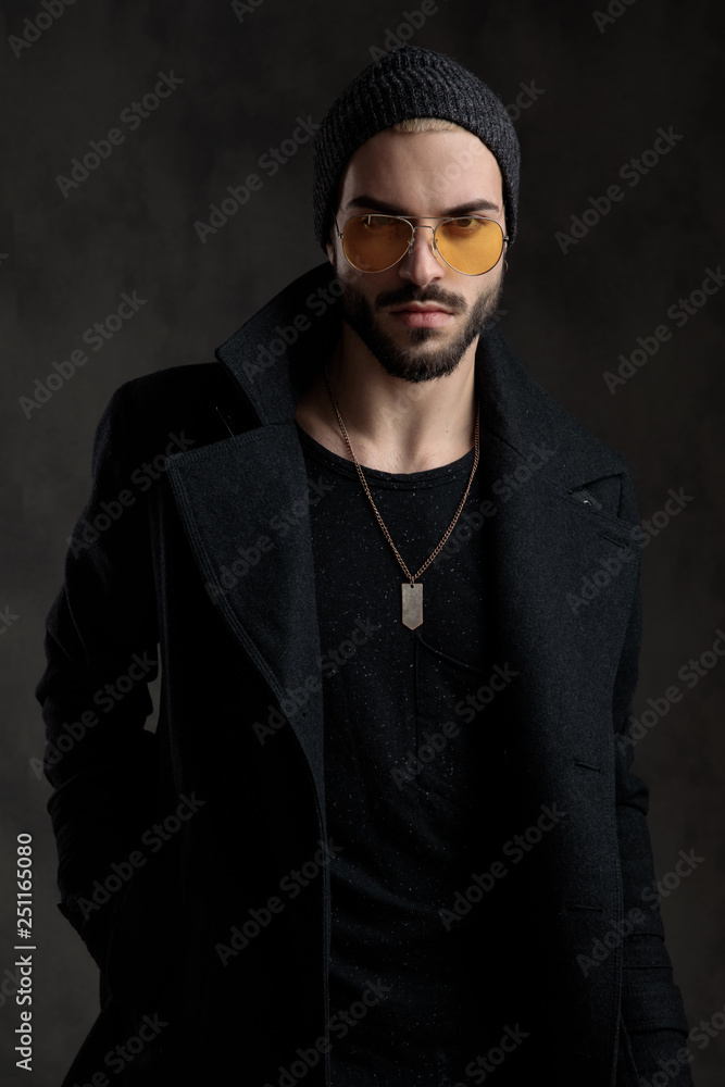 Well dressed holding his hand in the pocket