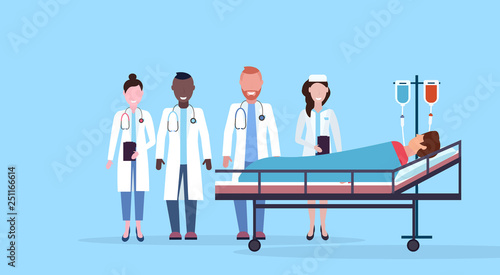 mix race doctors team visiting patient man lying bed intensive therapy ward healthcare concept hospital room blue bckground modern medical clinic horizontal