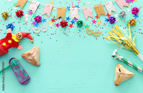 Purim celebration concept (jewish carnival holiday) over wooden mint background