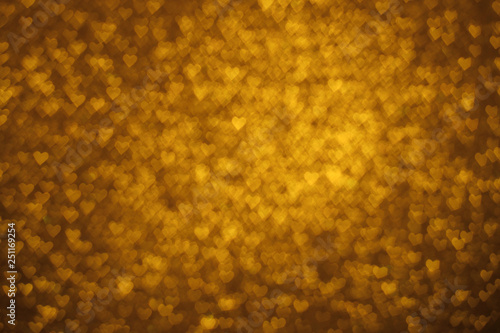  Abstrac golden background with heart form bokeh.