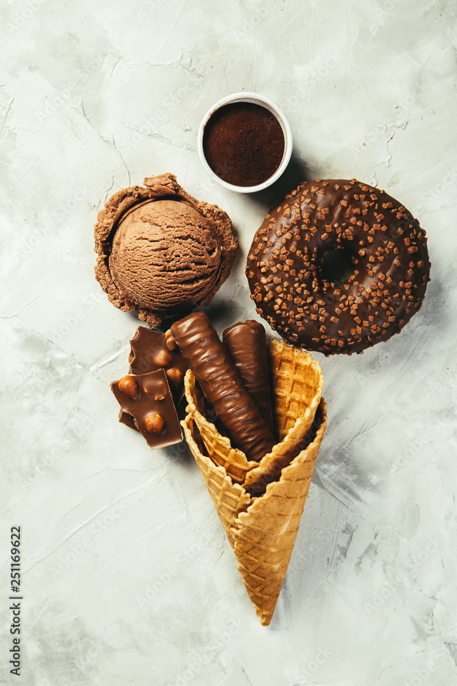 Selection of chocolate sweets - donut, ice cream, cookies, top view Selection of chocolate sweets - donut, ice cream, cookies, top view