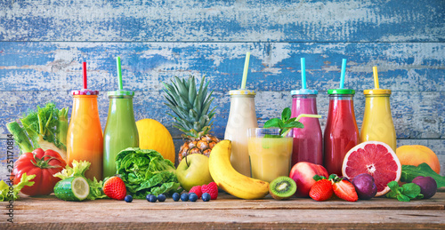 Fototapeta Naklejka Na Ścianę i Meble -  Colorful freshly squeezed fruits and vegetables smoothies with ingredients for healthy eating
