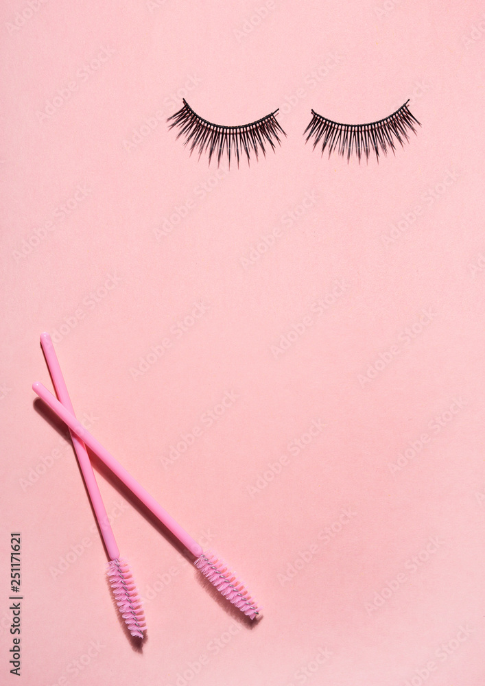 Creative concept beauty photo of lashes extensions brush on pink