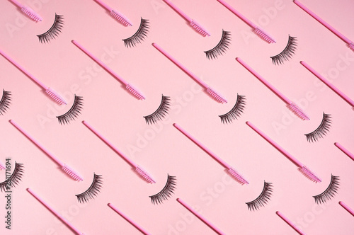 Fototapeta Creative concept beauty photo of lashes extensions brush on pink background