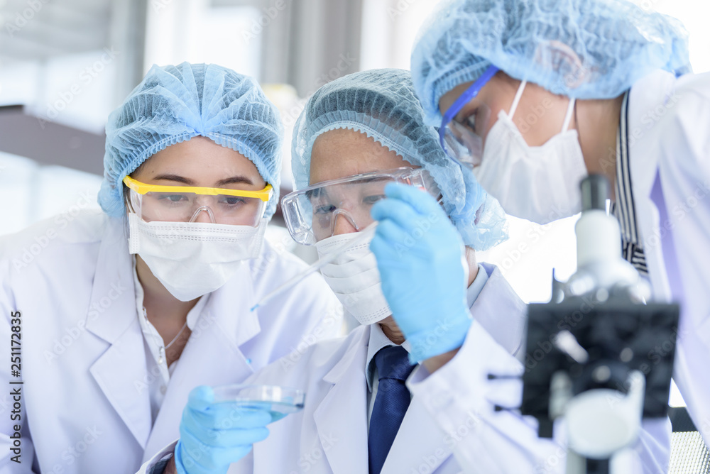Asian scientist team has researching in laboratory. Asian scientist team has researching in laboratory.